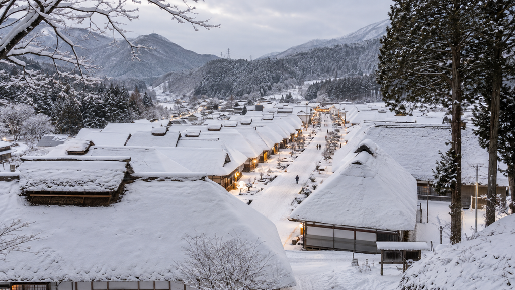 Snow-covered thatched-roof houses lining Ouchi-juku village in Fukushima